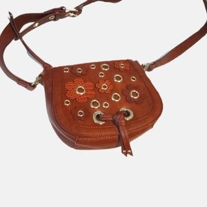 Nine West small Carmel color crossbody bag with flower accents.